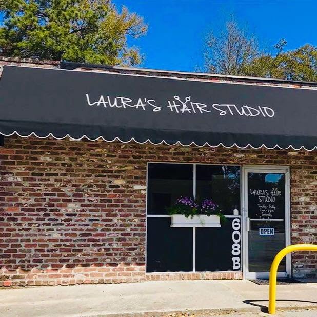 Laura’s Hair Studio from the street, with flowers in the window box