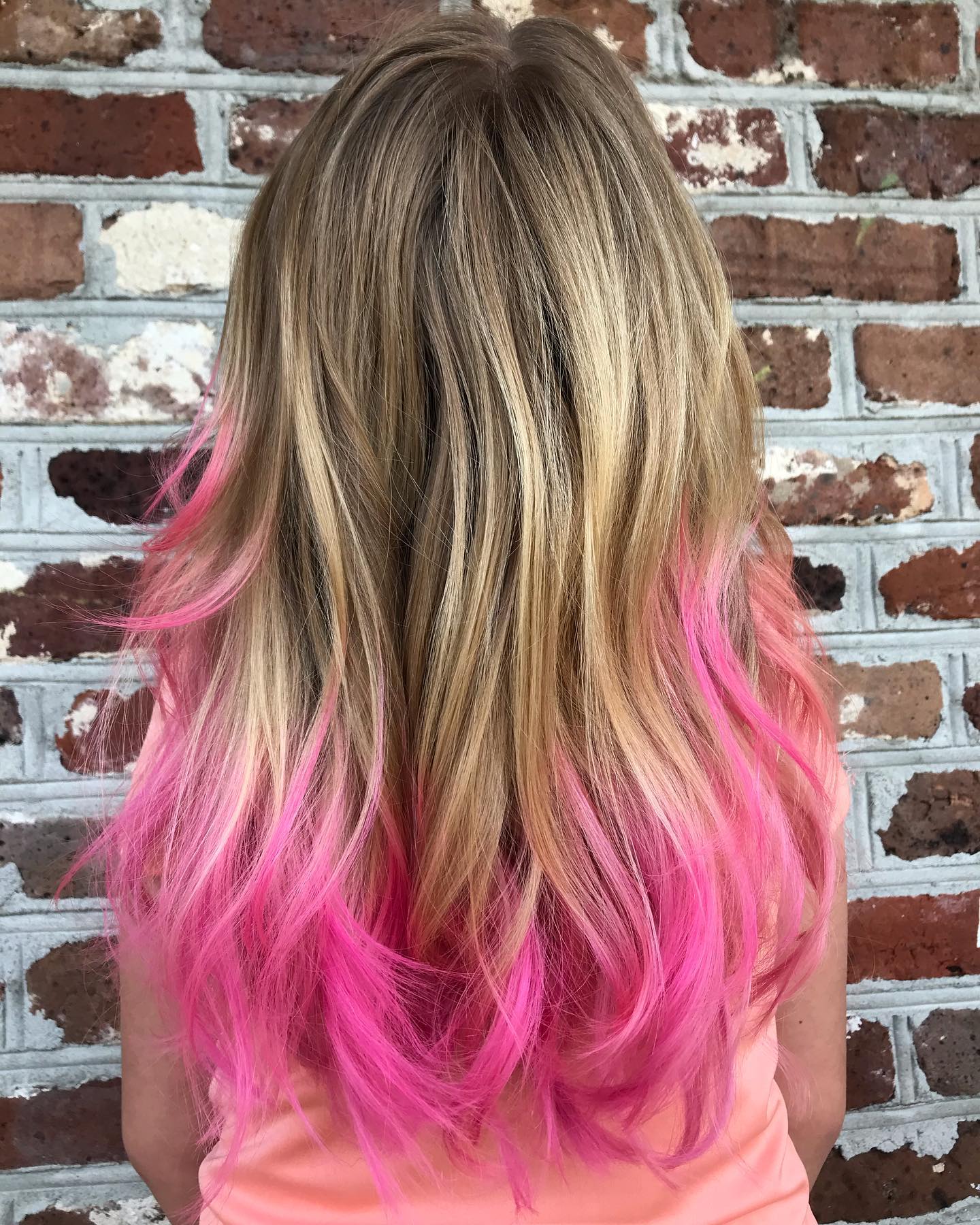Long blonde hair with bright pink dip-dyed ends