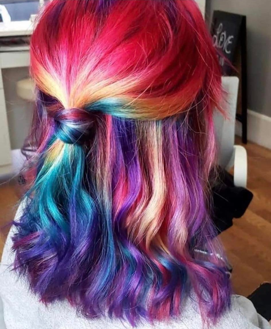 Rainbow hair color in red, purple, teal and gold